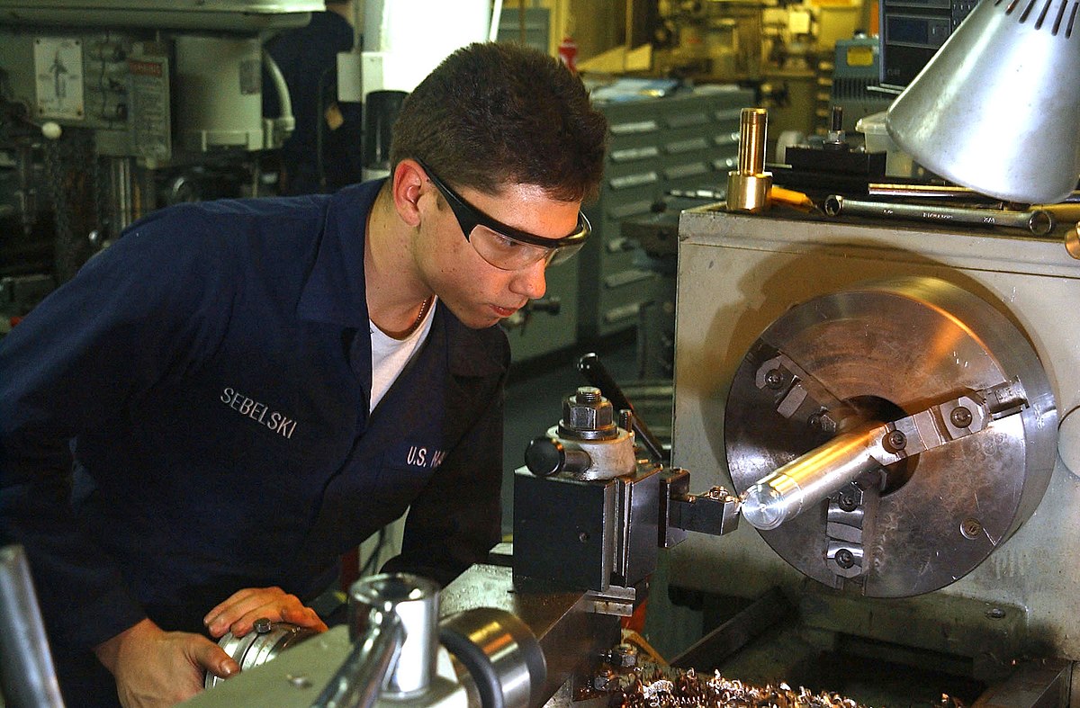 040225-N-6125G-038.Atlantic Ocean (Feb. 25, 2004) Đ Fireman Justin Sebelski fabricates specialized parts on a lathe in the machine shop aboard USS Harry S. Truman (CVN 75).  The nuclear powered aircraft carrier is currently undergoing carrier qualifications and flight deck certification off the Atlantic coast. U.S. Navy photo by Photographer's Mate Airman Eric S. Garst. (RELEASED).